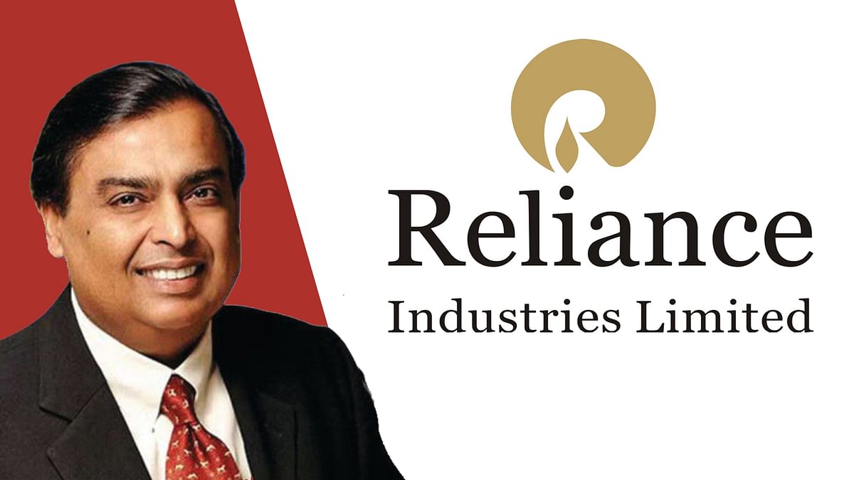 In this photo ullustration the logo of Reliance Industries Limited is seen  on a smartphone next to an illustration of the stock market. It is one of  the most important oil companies