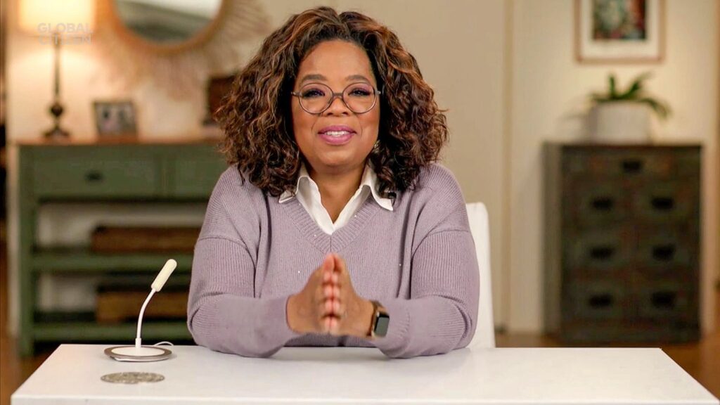 Oprah anchoring a news program, looking confident and composed at a news desk