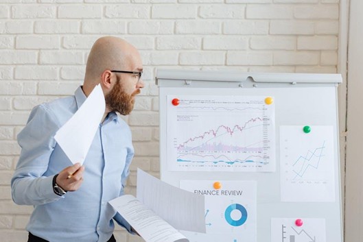Small business owner reviewing a laptop with accounting software open