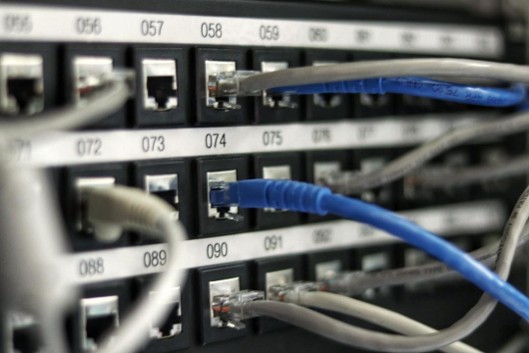 Rows of network servers connected with structured cabling in a data center