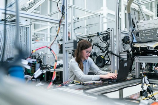 An engineer monitoring automated manufacturing equipment