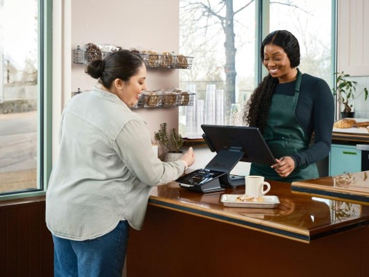 A small business owner reviewing paperwork at a shop counter