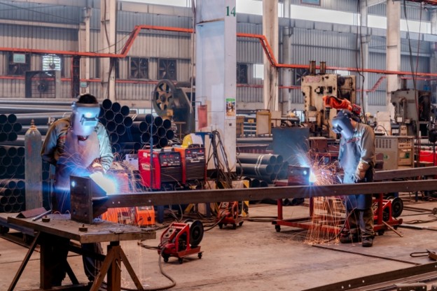 Welders Working in Workshop
