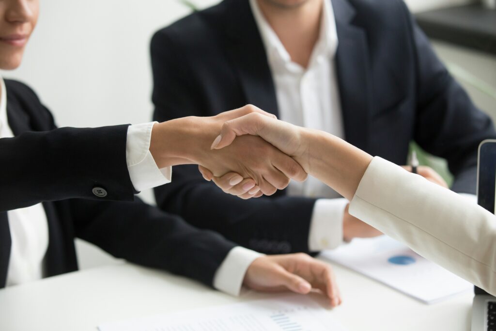 A handshake between a business owner and an insurance advisor